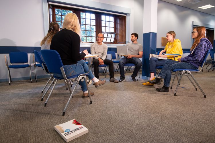 Students sitting in a semicircle in classroom